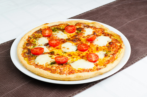 Pizza With Mozarella Fresh Tomatoes Pesto And Cheese