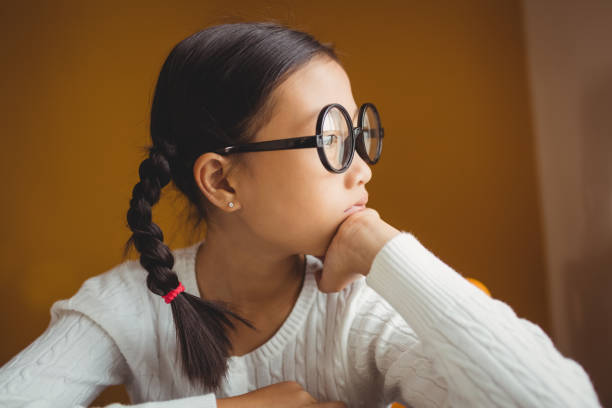 istock Schoolchild touching her chin 664365784