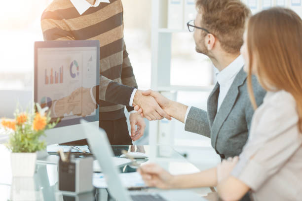 istock friendly handshake of employees in the workplace at the beginning 664370890