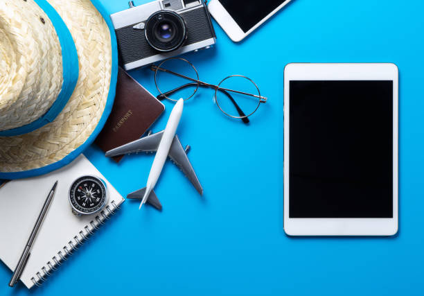 istock Blank tablet screen for mock up on blue background with summer travel accessories 664373562