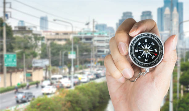 istock Holding a compass to travel in a busy city 664373620