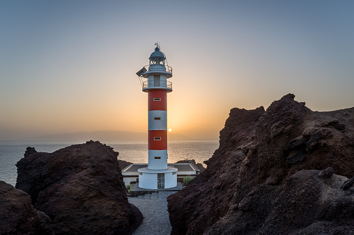 Punta de Teno Lighthouse and ocean view at sunset. Popular touristic destination at Tenerife island. Canary islands, Spain.