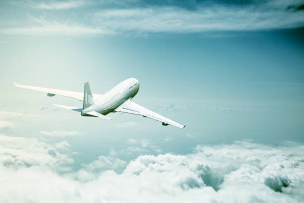 istock commercial airplane flying over the clouds 664374604