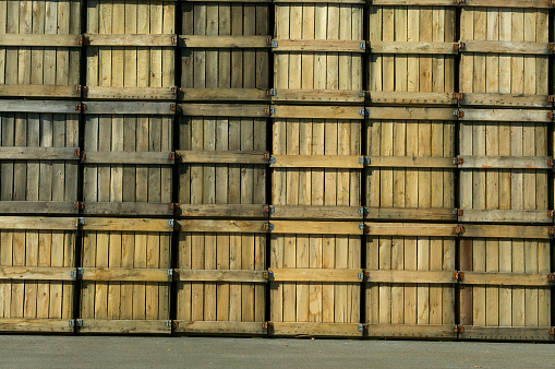 Wooden crates being stored outside.\