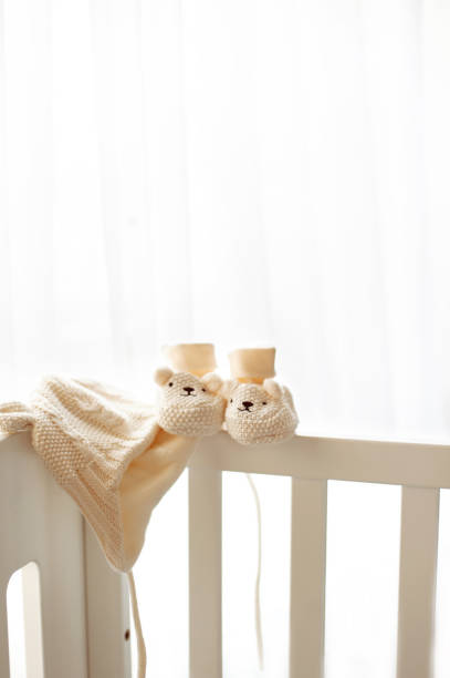 istock Waiting for a new life beginning. Knitted hat and booties 664385910