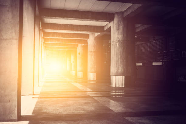 Concrete building hall walkway with light out at destination. vector art illustration