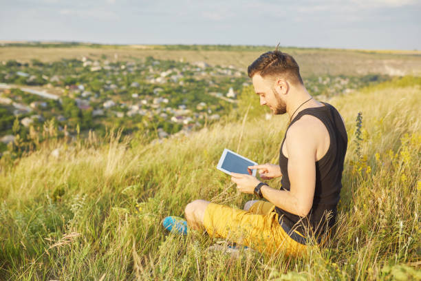 istock Young man smiling and enjoying sunny summer day 664386150