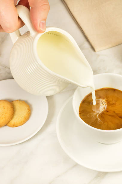 istock Milk poured into cup of coffee 664386376