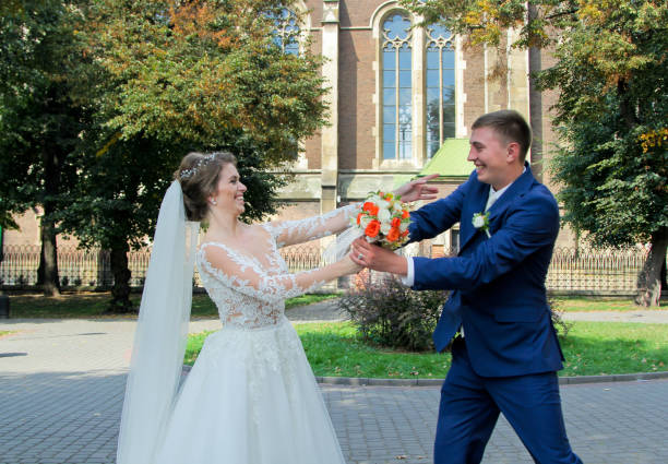 istock Wedding couple smiling and take away bouquet to each other 664386436