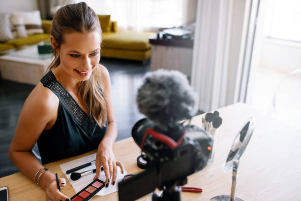 istock Young female vlogger recording a make-up video for her vlog. 664386806