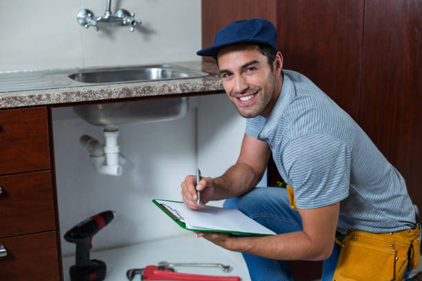 istock Portrait of smiling man writing on clipboard 664389274