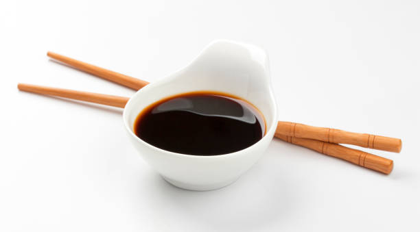 istock Soy sauce and chopsticks isolated on white 664389536