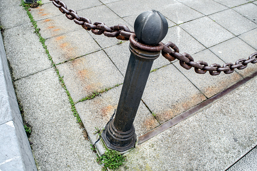 Bollard and chains on the street.