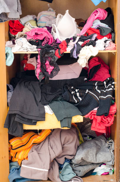 istock Pile of carelessly scattered clothes in wardrobe 664389942