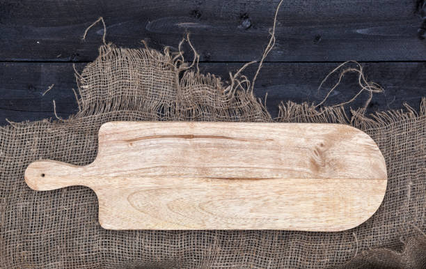 istock Empty vintage cutting board on wooden table 664390286