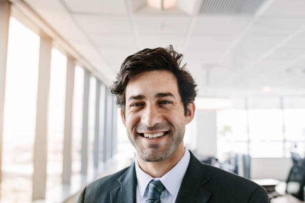 istock Successful young businessman standing in office 664390552