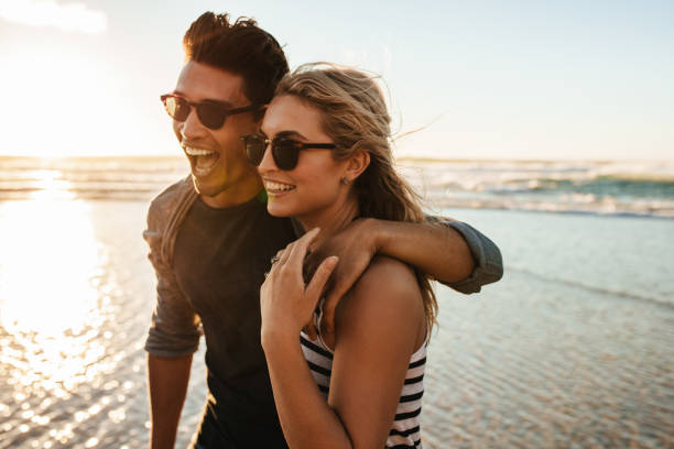istock Beautiful young couple on beach vacation 664392886