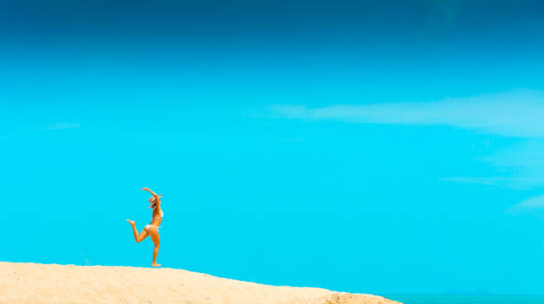 Woman in sunhat at tropical beach