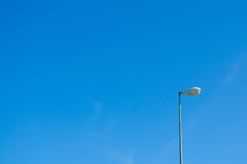 Light post on a sunny day, with a clear sky on the background.