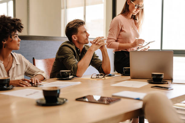 istock Corporate professionals sitting around table during meeting 664394430