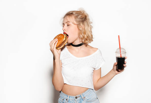 istock Slim trendy girl with hamburger and cola 664395410