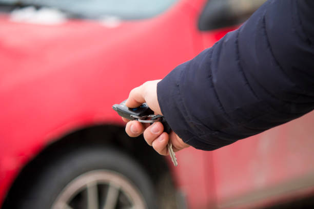 istock Men's hand presses on the remote control car alarm systems 664396514