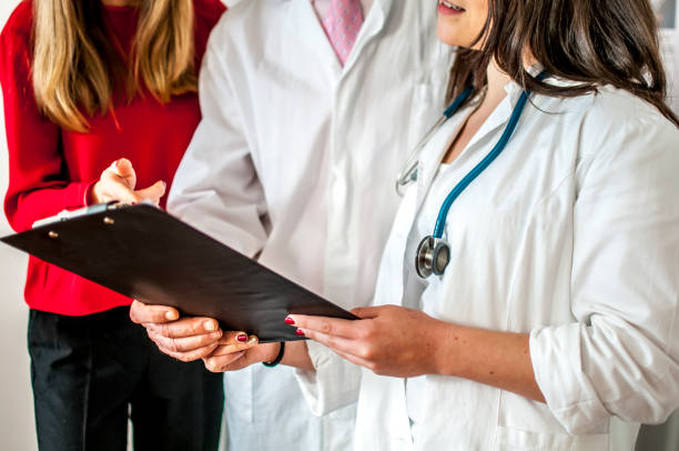 istock doctors in red and white shirts at work 664399196