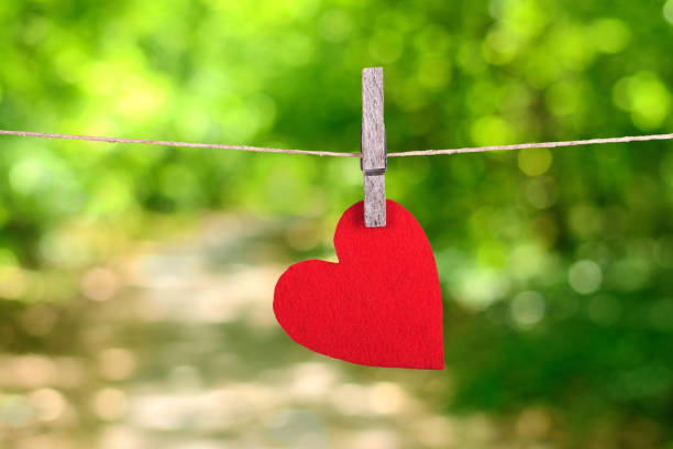 istock Red heart shape hanging, over the natural background 664405782