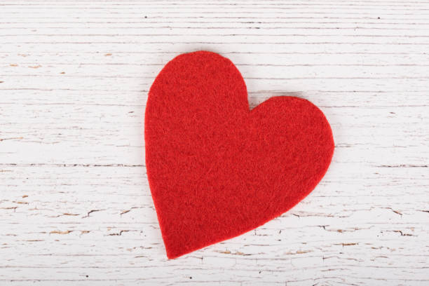 istock Red heart shape on a wooden background 664406260