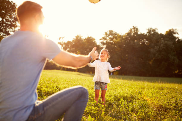istock Girl with father plays ball 664410006