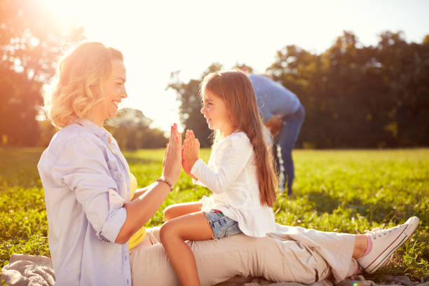 istock Mother play with daughter in nature 664410114
