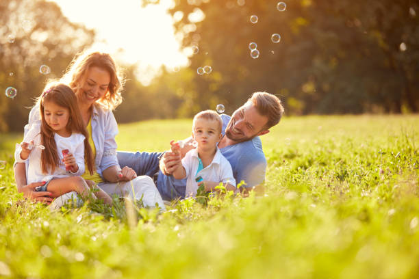 istock Children in nature make soap bubbles 664413614