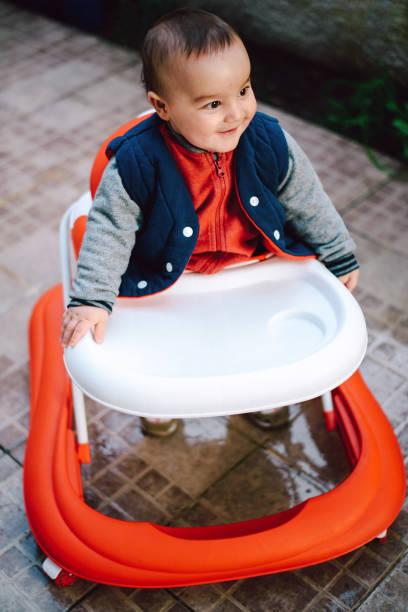 istock Cute baby in baby walker 664414642