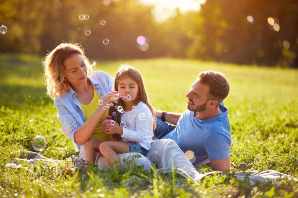 istock Child blow soup foam and make bubbles in nature 664416906