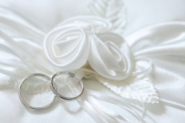 istock gold wedding rings on satin pillow 664418230