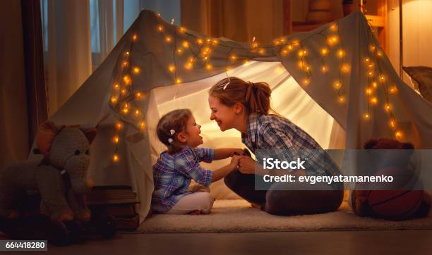 Happy Mother And Daughter Playing At Home In Tent Stock Photo - Download Image Now - Family, Child, Mother