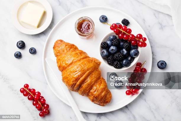 Croissant With Fresh Berries And Butter On A Marble Texture Background Top View Stock Photo - Download Image Now