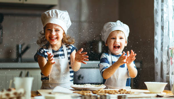 happy family funny kids bake cookies in kitchen - chef baker bakery flour imagens e fotografias de stock