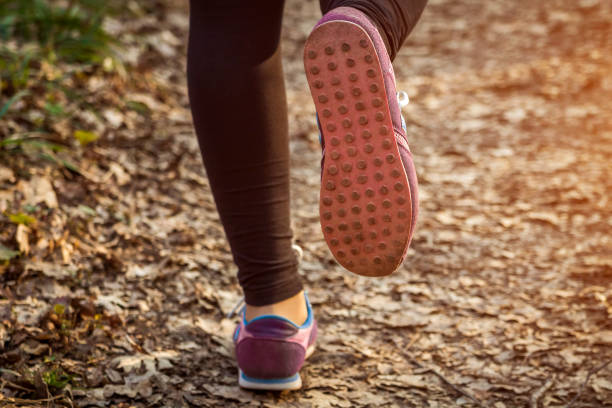 istock Woman running in the forest 664420988