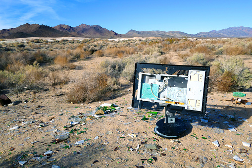 Older computer Shattered by bullets in the Mojave Desert. Southern California.