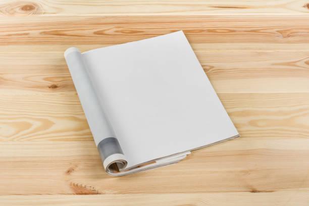 istock Mock-up magazines or catalog on natural wooden table background. 664421312