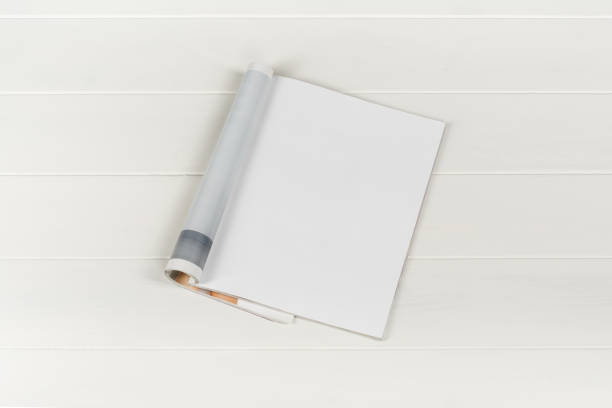 istock Mock-up magazines or catalog on white wooden table background. 664421418