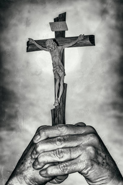 istock Cross in hands and dark sky 664421606