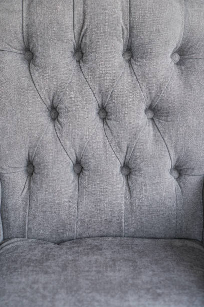 istock Seamless background texture close up of a grey sofa back with button detail on a thick cloth 664424216