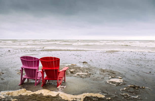 istock Stormy Lake Beach with outdoor Chairs 664424730