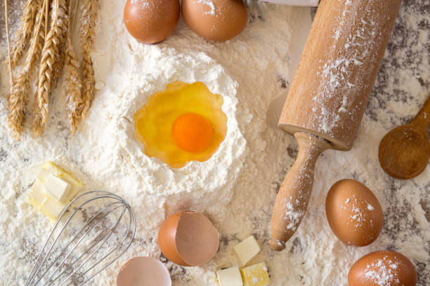 istock eggs, dough, flour and rolling-pin baking cakes on wooden table 664428200