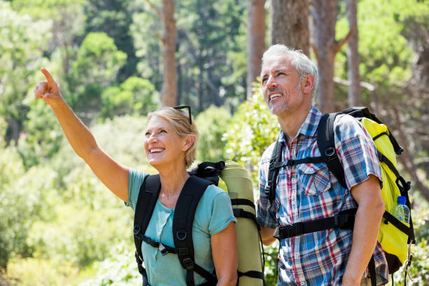 istock senior couple standing and smiling 664428768