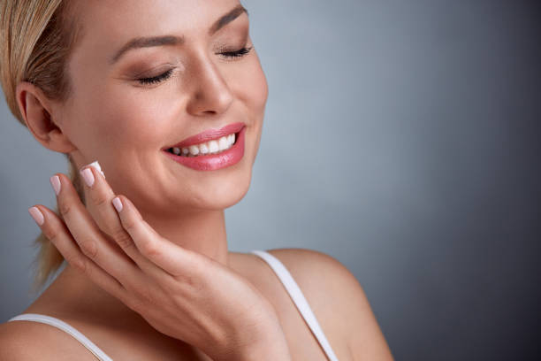 istock Middle aged woman enjoying in face cream 664428804