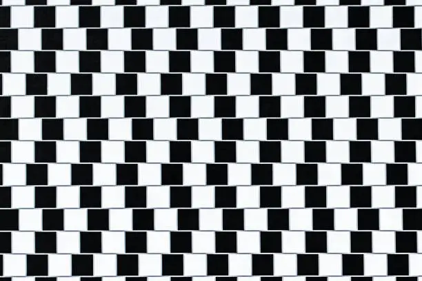 Lines are parallel but seem to be slanted - optical illusion.