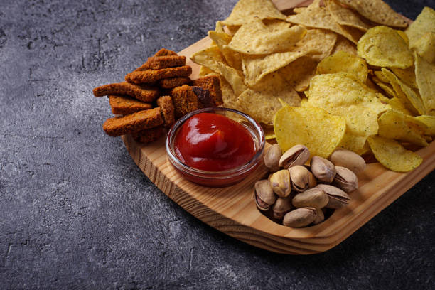 istock Assorted of snack. Chips, pistachios, nachos and peanuts 664431898